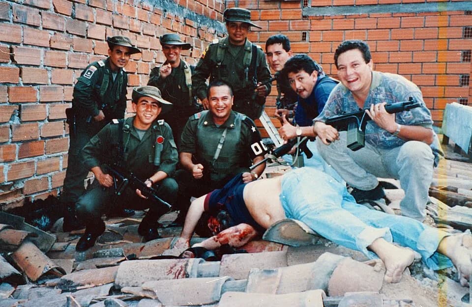 Pablo Escobar - Members of Colonel Martinez's Search Bloc celebrate over Pablo Escobar's body on December 2, 1993. Pablo's death ended a fifteen-month effort that cost hundreds of millions of dollars.