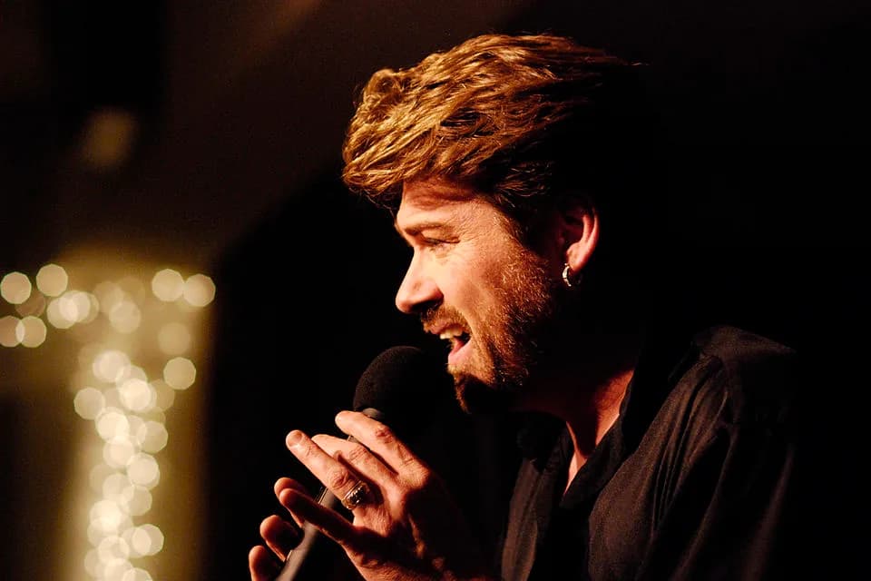 George Michael - A celebrity impersonator of George Michael, singing at a nightclub.