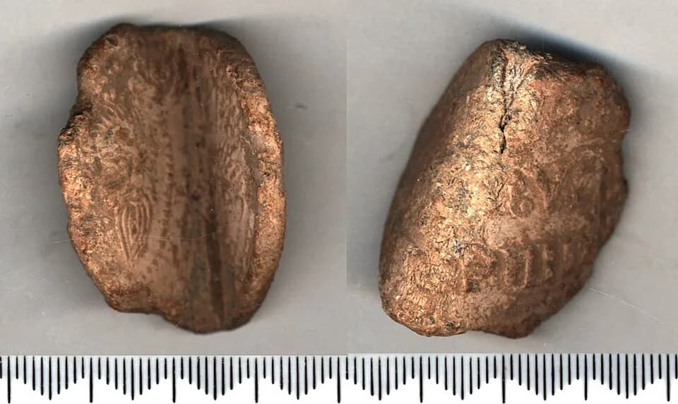 Martin IV - Lead papal bulla, now sharply bent; the bend has caused stress to the metal. On one face are the busts of St Peter (on the right) and St Paul (on the left) with the usual distinguishing fe