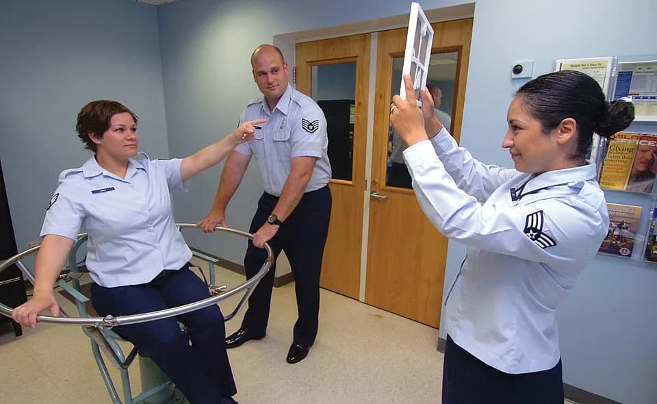Robert Bárány - Air Force personnel demonstrating the effect on the sensory perception and spatial orientation of a test person in a Bárány chair. After first having been rotated in the chair and then