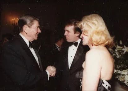 Ivana Trump - Ronald Reagan shaking hands with Donald Trump. Ivana Trump is standing beside.