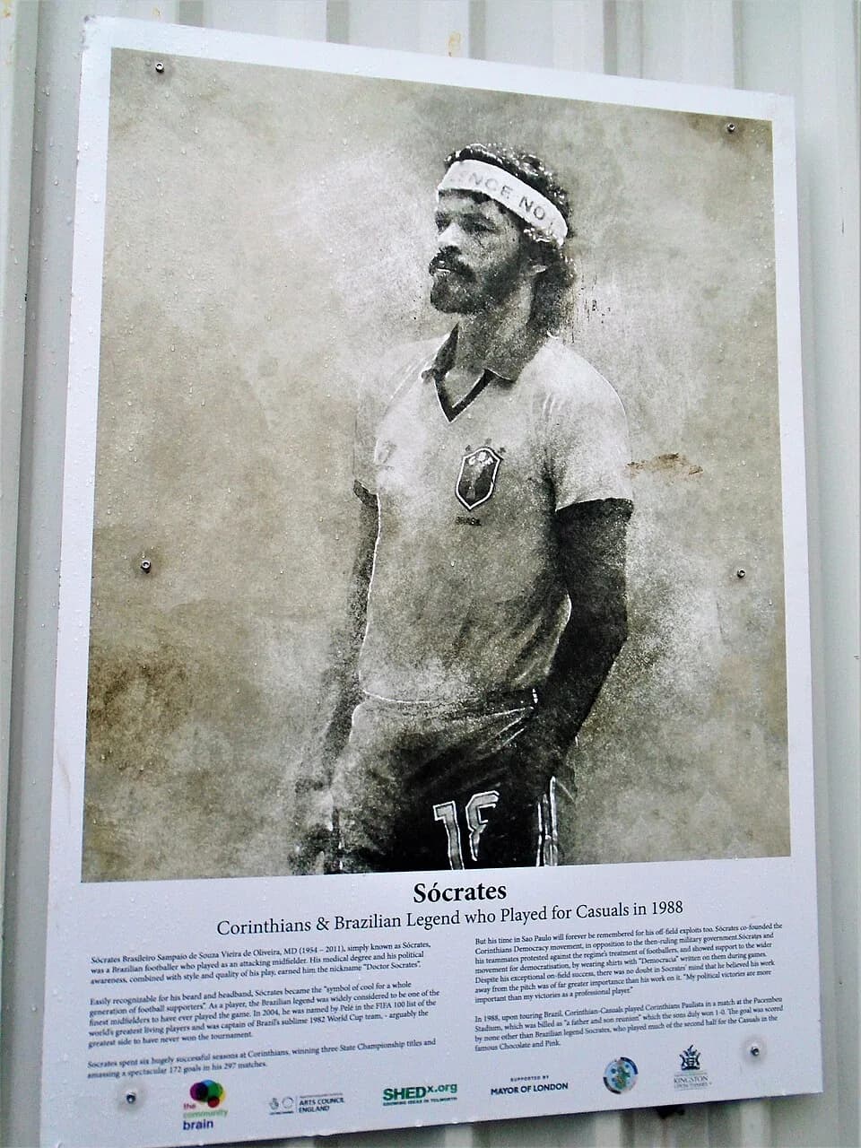 Sócrates Sócrates - Panel about Brazilian footballer Sócrates (1954-2011), who played in a friendly for Corinthian-Corinthians in 1988, at the club's home ground at King George's Field in Tolworth, Su