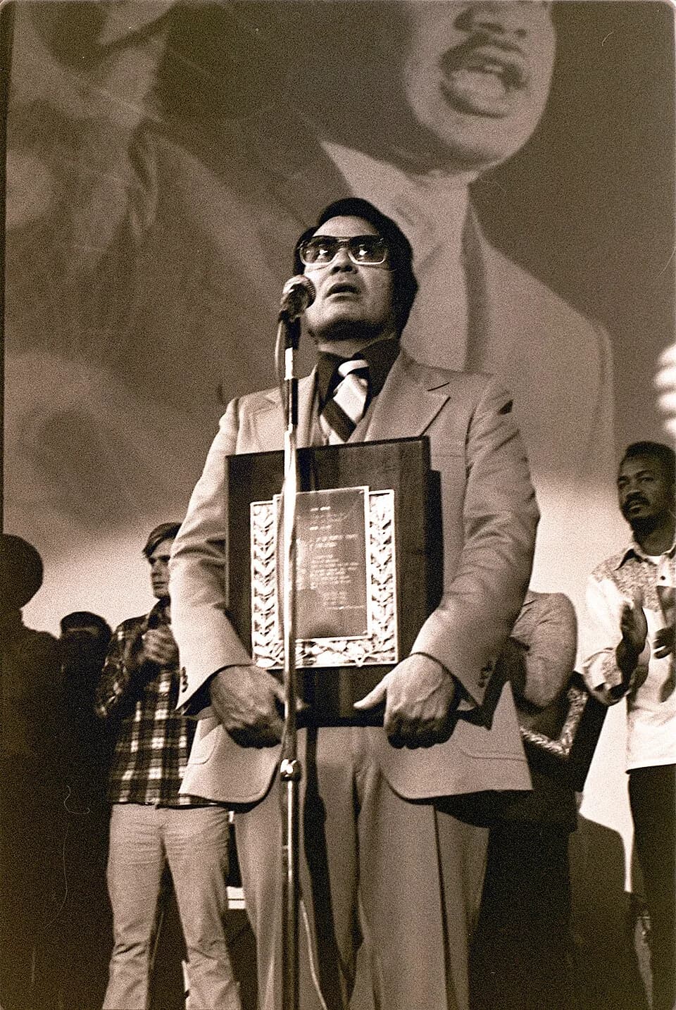 Jim Jones - Jim Jones, leader of the Peoples Temple, receives a Martin Luther King, Jr. Humanitarian Award from Glide Memorial Church, San Francisco January 1977. Photo by Nancy Wong