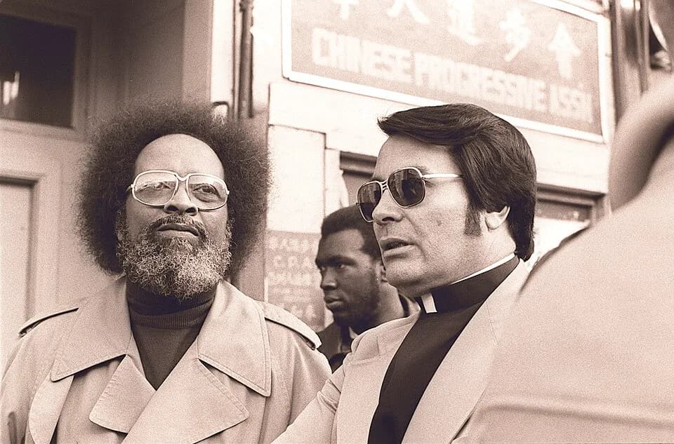 Jim Jones - Reverend Jim Jones of People's Temple (r) with Reverend Cecil Williams of Glide Memorial Church in front of the International Hotel on Kearny and Jackson Streets in San Francisco at a prot