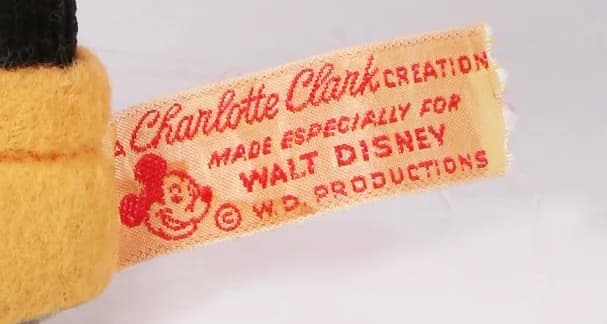 Walt Disney - Rare embroidery label applied to handmade creations by Charlotte Clark between 1930-1939. The label consists of four lines of text, accompanied on the left by the face of Mickey Mouse
