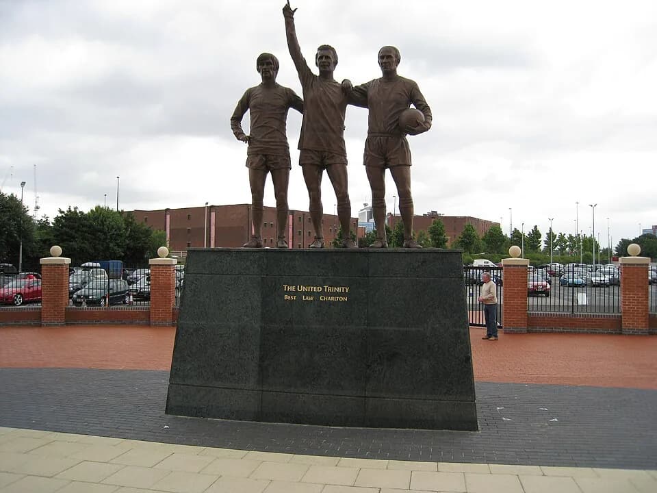 Denis Law - The Manchester United "triumvirate" of the 1960s - George Best, Denis Law and Booby Charlton - on pedestal outside Old Trafford stadium.