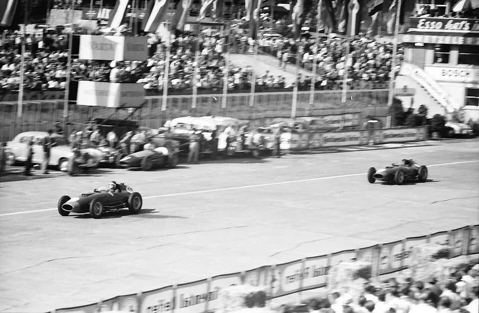Mike Hawthorn - The Ferrari 801 cars of Mike Hawthorn (leading) and Peter Collins pass the retired Maserati 250F car of Paco Godia, in the latter stages of the 1957 German Grand Prix at the Nürburgrin