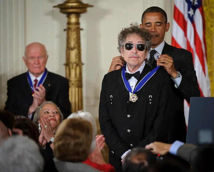 Toni Morrison - President Barack Obama presents American musician Bob Dylan with a Medal of Freedom, Tuesday, May 29, 2012, during a ceremony at the White House in Washington as Sen. John Glenn and no