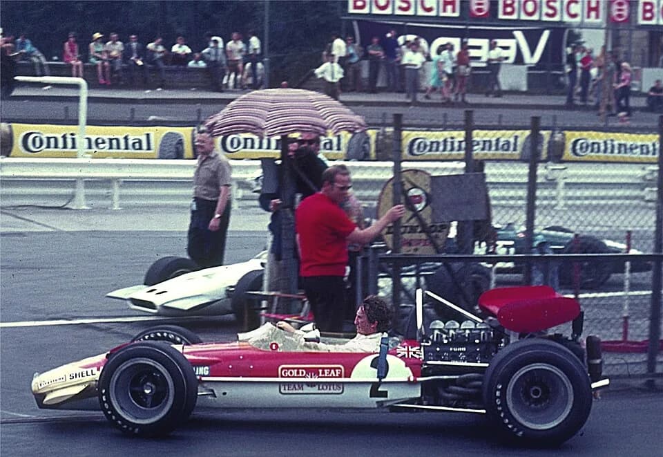 Jochen Rindt - Jochen Rindt with Lotus 49 B at entrance to the drivers' paddock of Nürburgring coming from the back straight after practice for German Grand Prix.