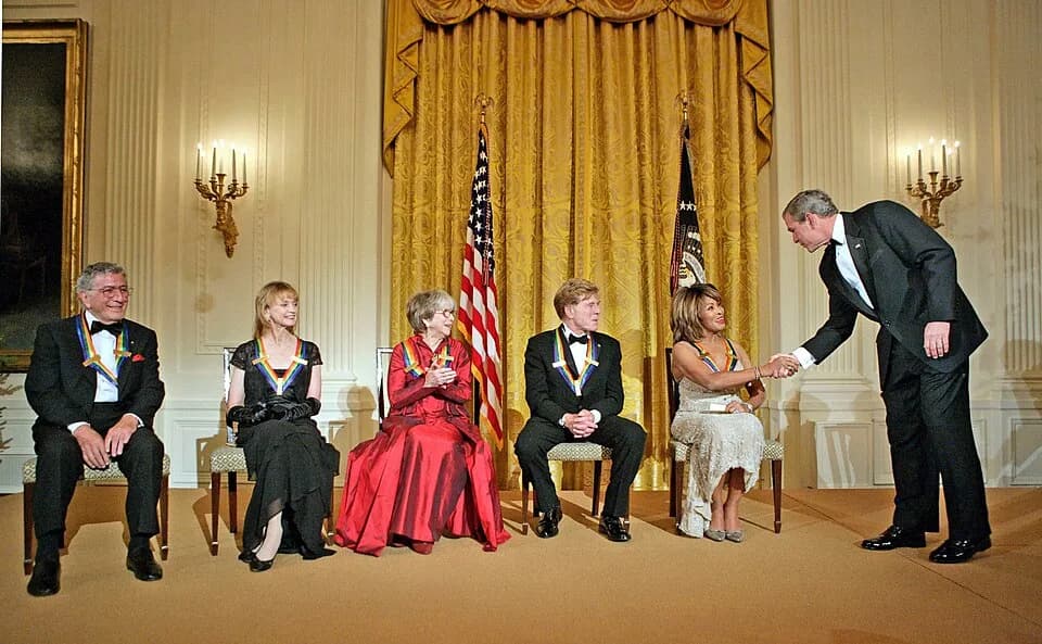 Tony Bennett - President George W. Bush congratulates Tina Turner during a reception for the Kennedy Center Honors in the East Room of the White House Sunday, December 4, 2005. From left, the honorees