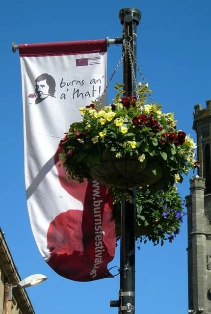 Robert Burns - Burns An' A' That! One of the banners in central Ayr, celebrating the 250th anniversary of the birth of Robert Burns. The building on the right is the Wallace Tower, in the High Street
