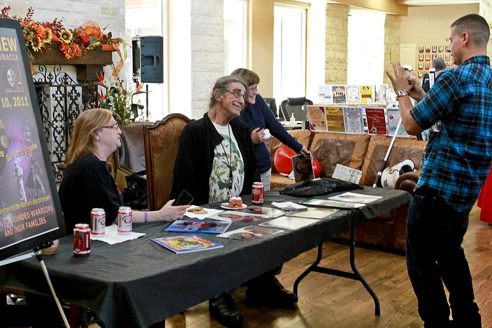Peter Mayhew - Peter Mayhew, who played the character Chewbacca in "Star Wars," poses for a picture as he signs autographs during an event at the Warrior and Family Support Center in San Antonio, Nov.