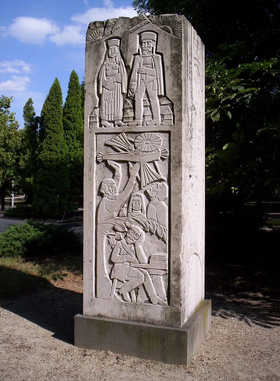 Mór Jókai - Jókai monument in the Castle Park in Pápa, Hungary, inaugurated in 1978. Art by Jenő Szervátiusz. On the four sides of the stone the characters of Mór Jókai's novels are depicted.