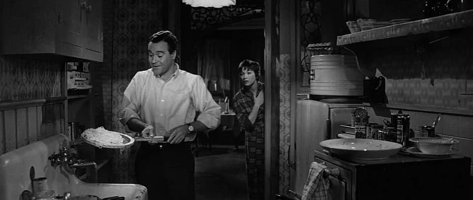 Jack Lemmon - Screenshot of Jack Lemmon as C.C. Baxter using a tennis racket to strain spaghetti in the trailer for the film The Apartment (1960)
