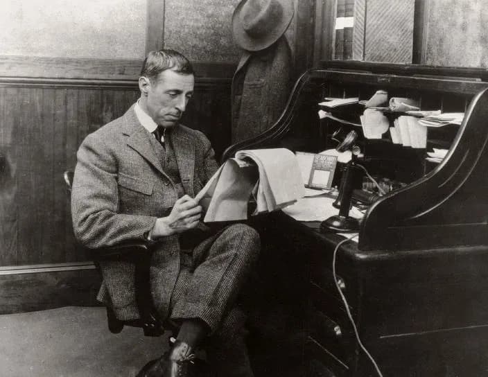 D. W. Griffith - Photograph of movie director D. W. Griffith sitting at a rolltop desk. Courtesy of the New York Public Library Digital Collection.
