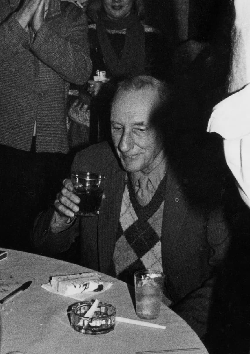 William S. Burroughs - William Burroughs enjoying cake and alcohol at his 70th birthday.