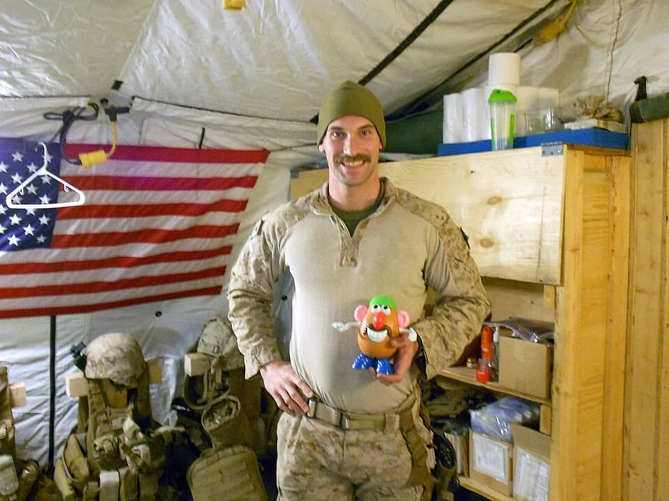Don Rickles - Petty Officer 3rd Class Kristopher Krysa, 27, from La Grange Park, Ill., a corpsman with Security Force Assistance Advisor Team 2-215, holds his Mr. Potato Head toy aboard Forward Operat