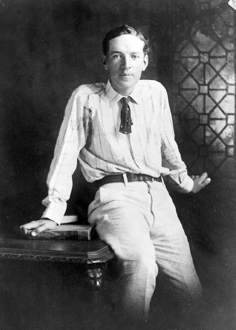 Upton Sinclair - Upton Sinclair, three-quarter length portrait, seated on desk, facing front. Forms part of: New York World-Telegram and the Sun Newspaper Photograph Collection.