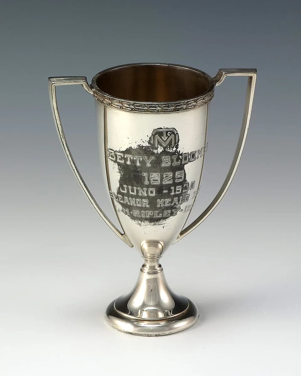 Betty Ford - Silver, loving cup tennis trophy awarded to Betty Bloomer from Central High School. Engraving reads, “TM / Betty Bloomer / 1929 / Juno - 1930 / Eleanor Heald - 1931/ L-M-Ripley - 193