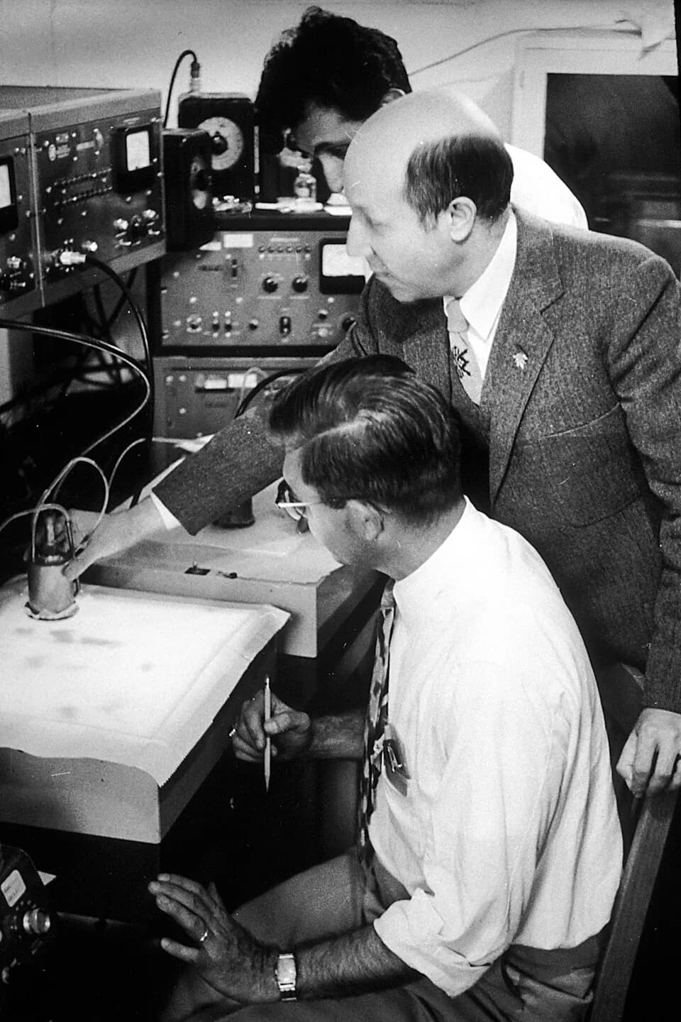 Melvin Calvin - Title Calvin, Melvin
Description Mr. Calvin surrounded by two other men, holding scientific apparatus. An American chemist most famed for discovering the Calvin cycle along with Andrew